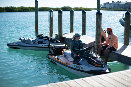 People on dock and personal watercraft