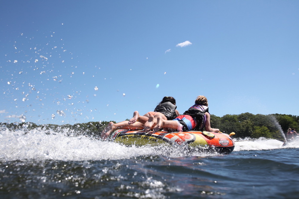 boat tubing behind a boat