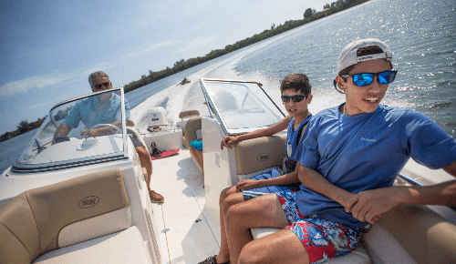 Family on boat towing innertube