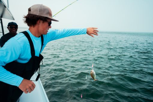 Man holding fish on rod